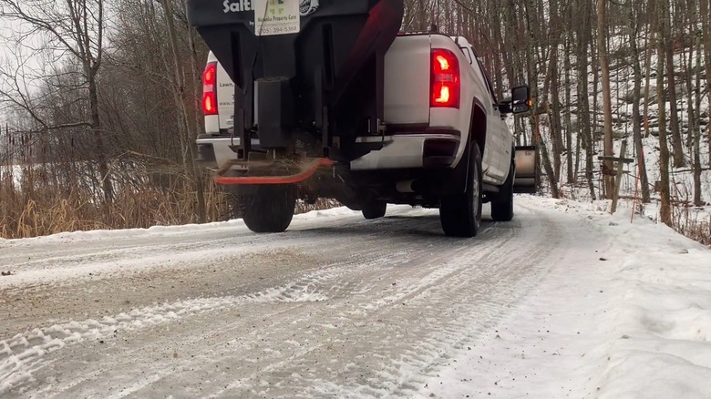 A Pickup Using A Tailgate Salt And Sand Spreader