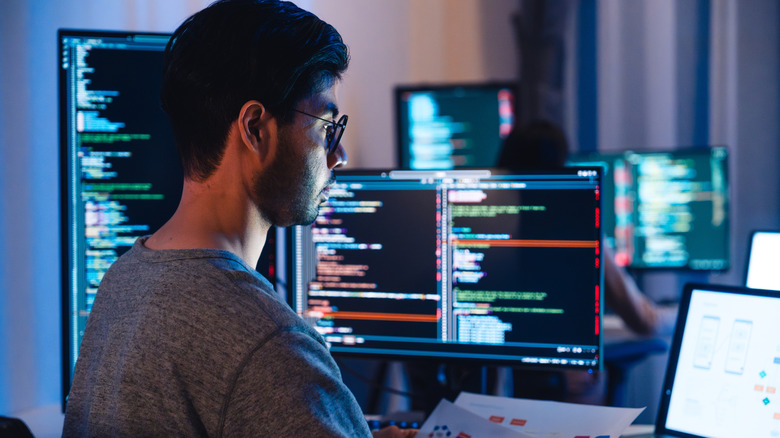 man in front of monitors