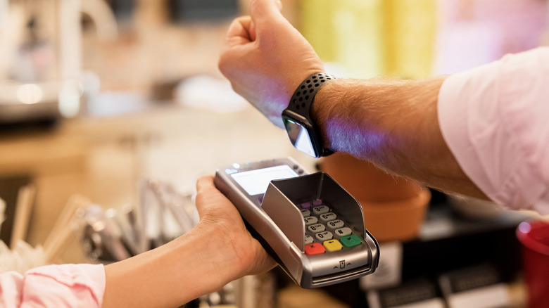 Person paying with Apple Watch