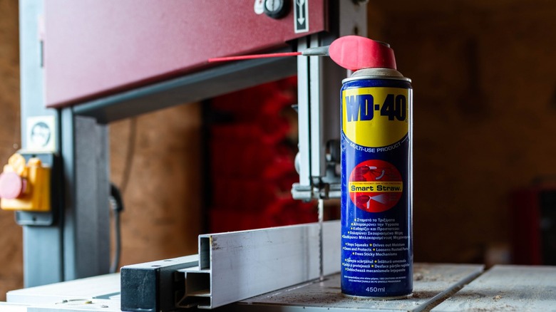 WD-40 can posed on bandsaw table