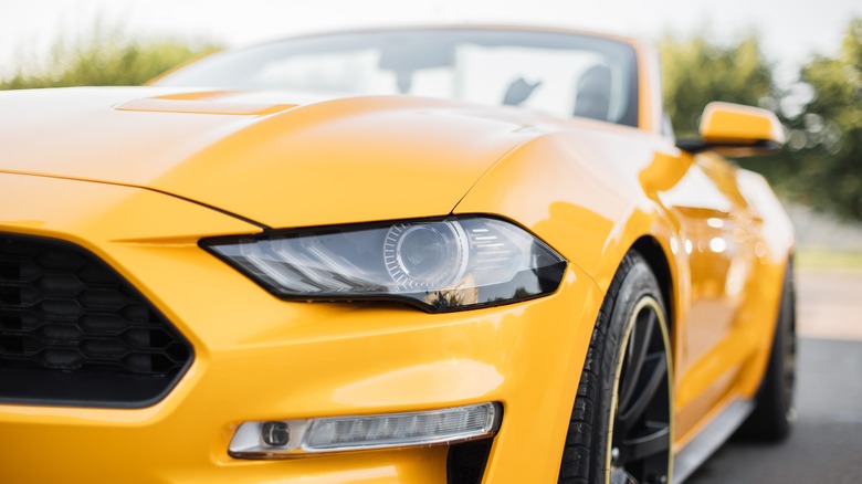 Yellow Ford Mustang headlight closeup