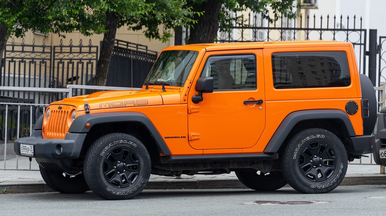 Orange Jeep Wrangler parked street