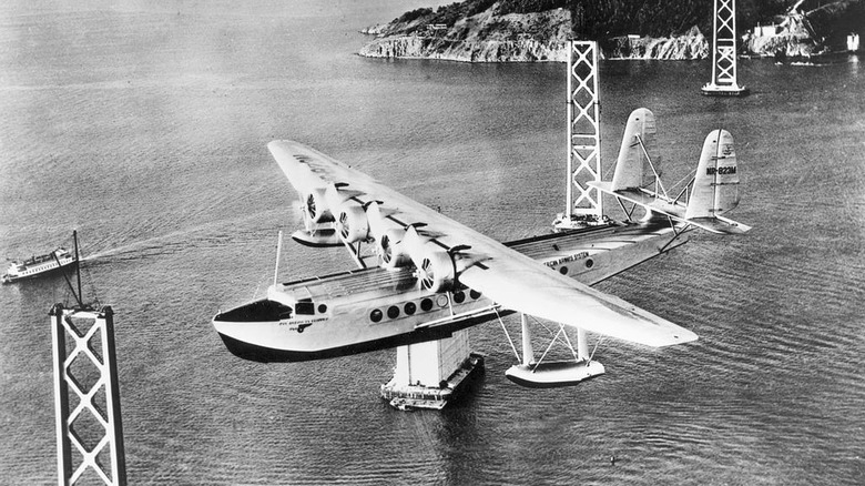 Pan American Airways Sikorsky S-42 "Pan American Clipper" (r/n NR-823M; c/n 4201) in flight over San Francisco Bay on its way to Hawaii. San Francisco-Oakland Bay Bridge construction is visible, circa 1934.