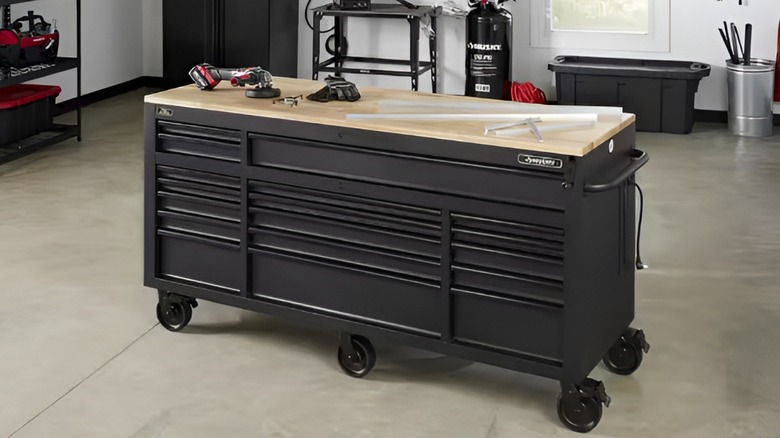 Husky tool chest with wooden work top in middle of garage