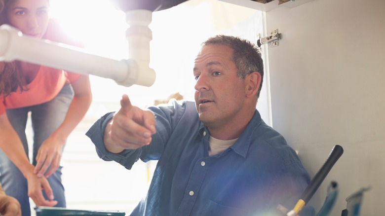 plumber working on pipe