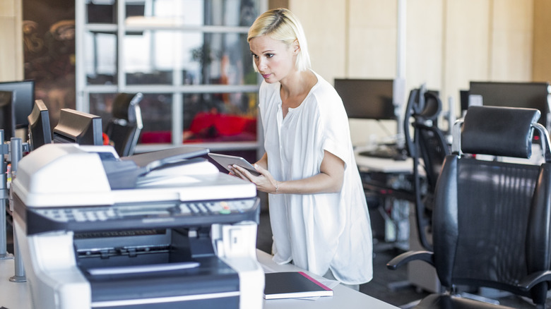 Person using printer in office