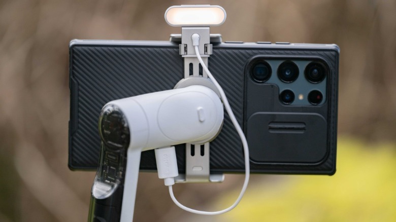 Insta360 Flow holding smartphone and light
