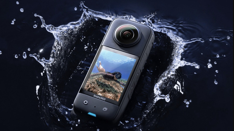 Black Insta360 X3 splashing into water