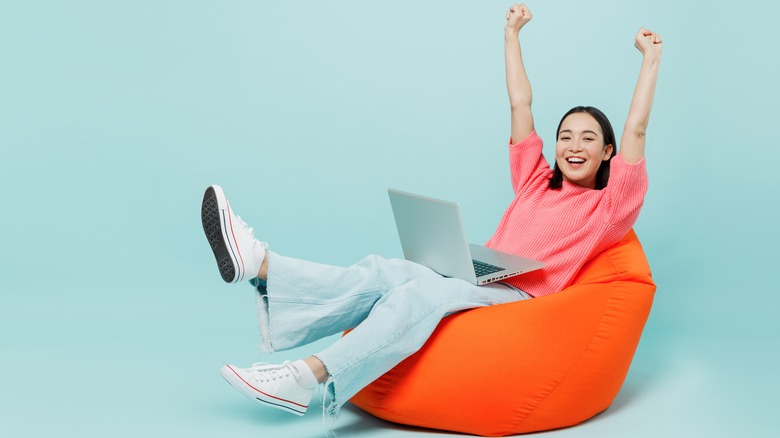 Person using laptop in chair