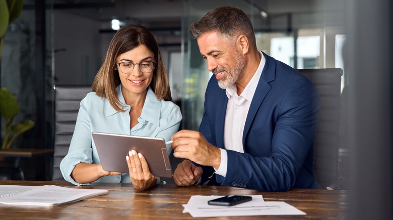 Two people using a tablet