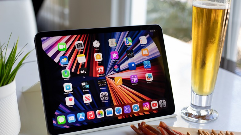 iPad on table next to glass of beer