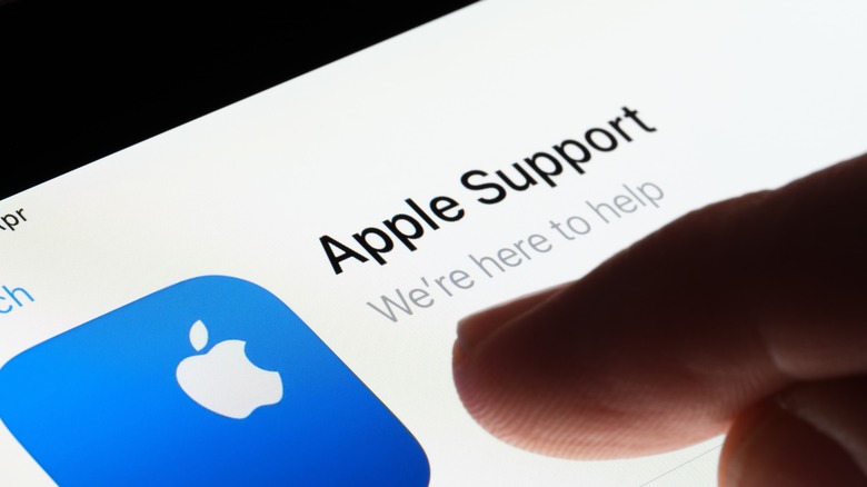 person tapping Apple Support on iPad