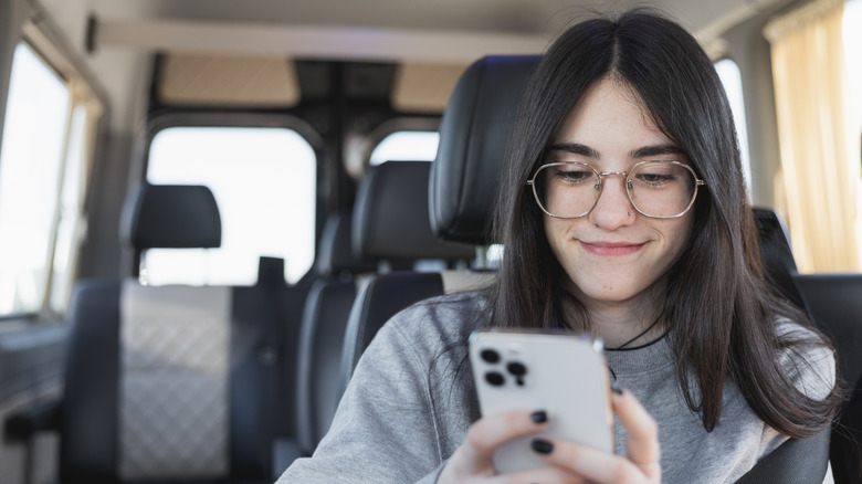 girl smiling at her iPhone