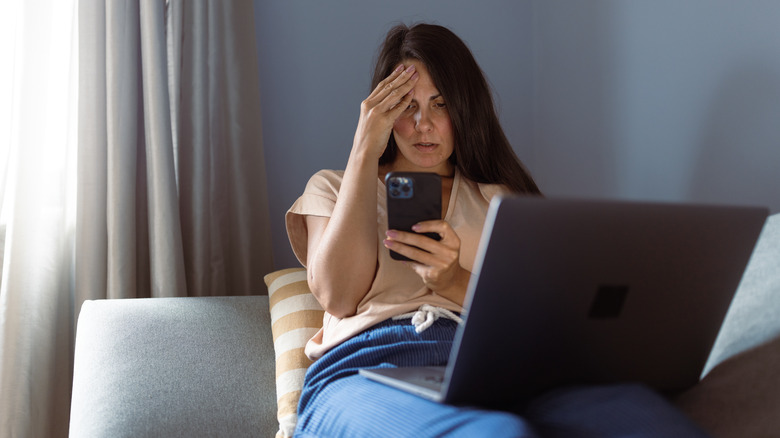 Distressed person looking at their iPhone