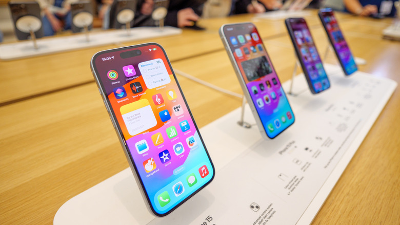 A series of iPhone 15 models on display at an Apple store