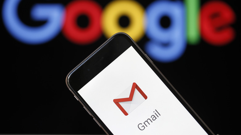 Gmail logo on phone and Google letters in the background