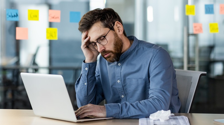 Person frustrated at laptop