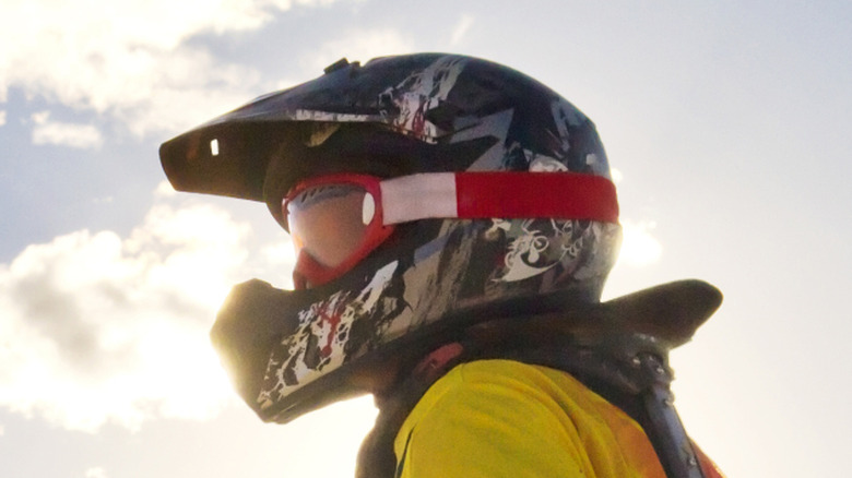 A dirt bike rider wearing a helmet.