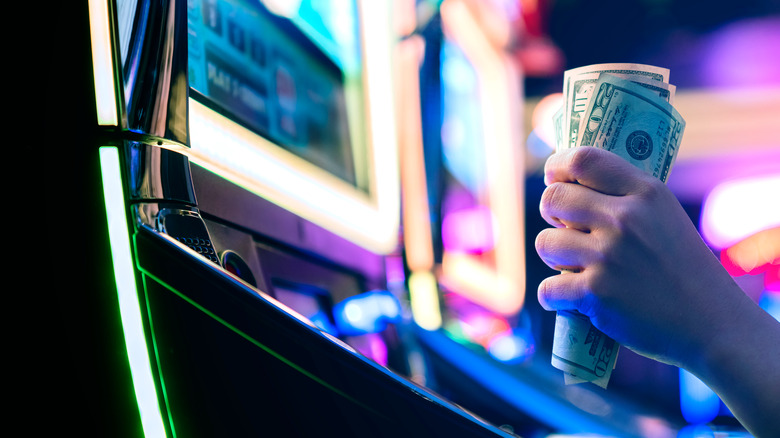 Hand with cash in casino