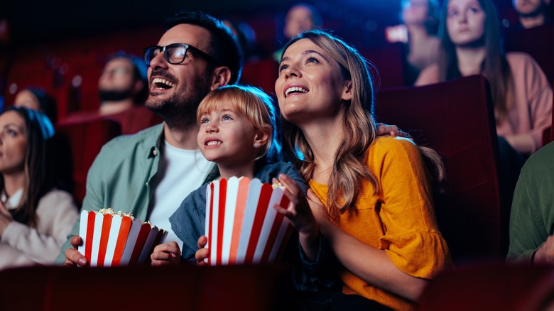 family watching movie popcorn