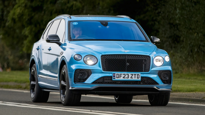 A blue Bentley Bentayga SUV running on the road