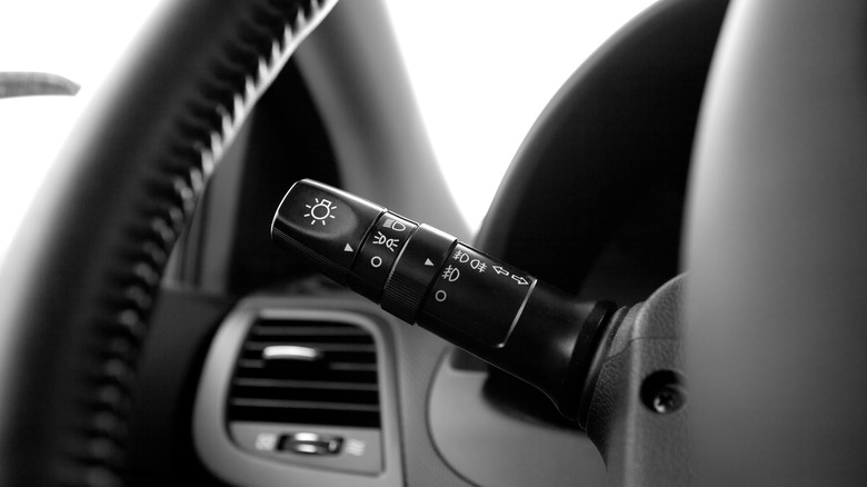 A car's turn-signal lever on a steering wheel