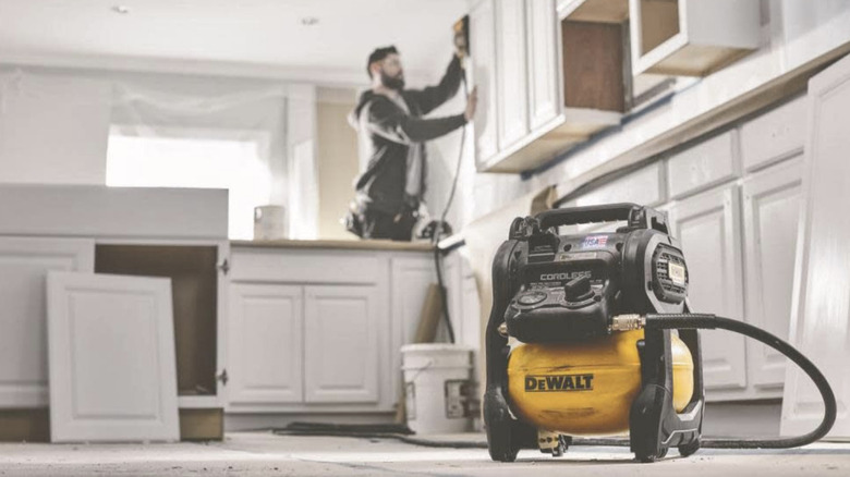 DeWalt 20V Air Compressor being used to install cabinents