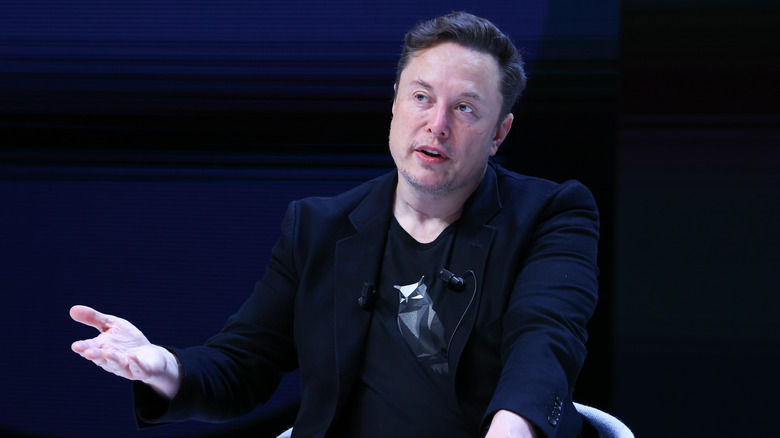 Elon Musk gesturing on stage