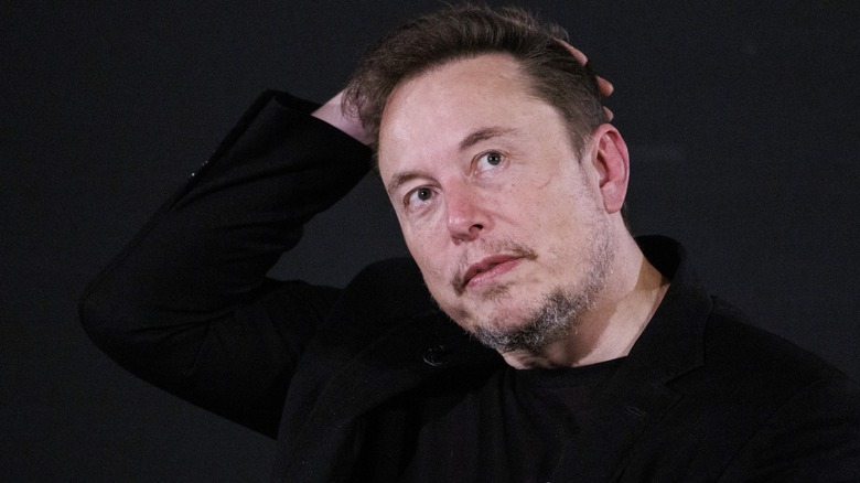 Elon Musk running hand hair