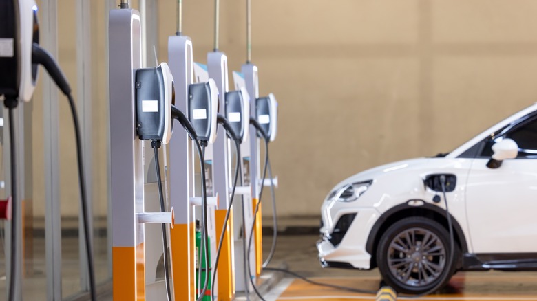 Electric vehicle being charged near charging stations 