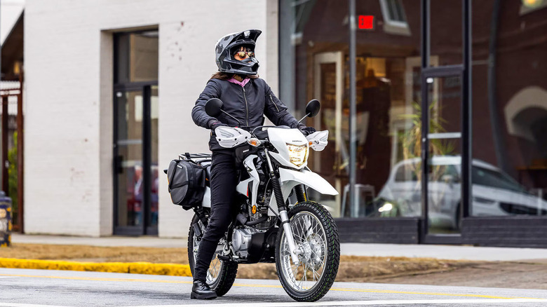 person riding honda xr150l motorcycle