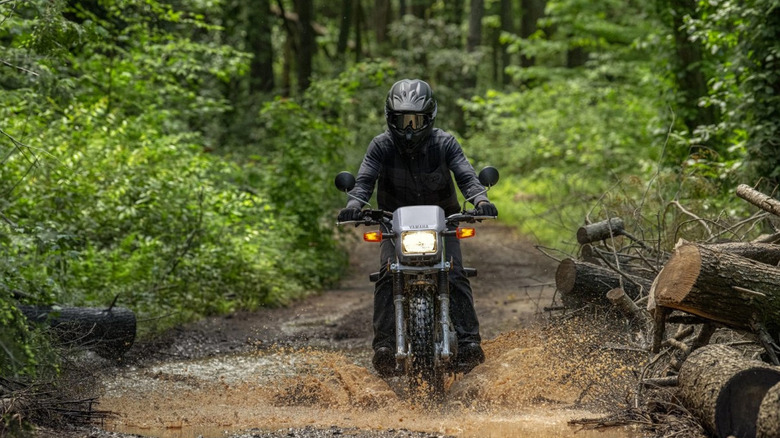 person riding yamaha tw200 motorcycle