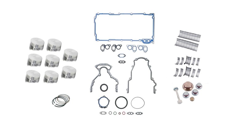 Chevy LS engine rebuild kit parts spread out on white background