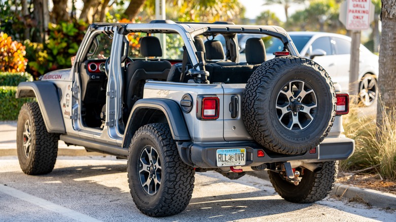 Four-door Jeep Wrangler parked with the doors removed