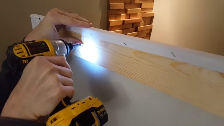 using a drill for a projector screen