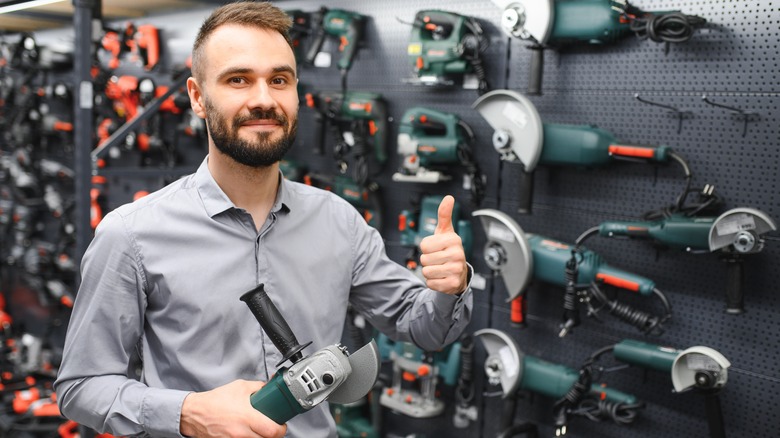 man giving a thumbs up with tools