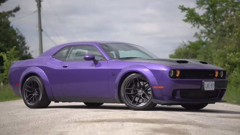 A purple 2019 Dodge Challenger hellcat redeye widebody parked on a vacant road