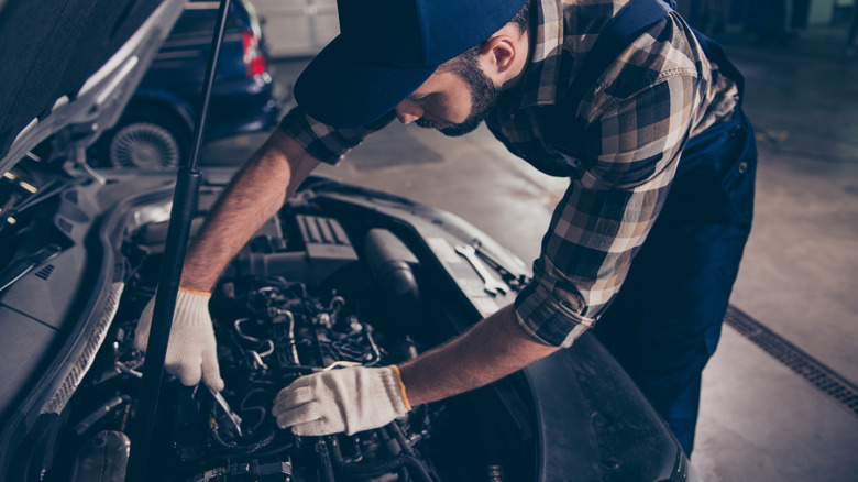 Mechanic works on a car