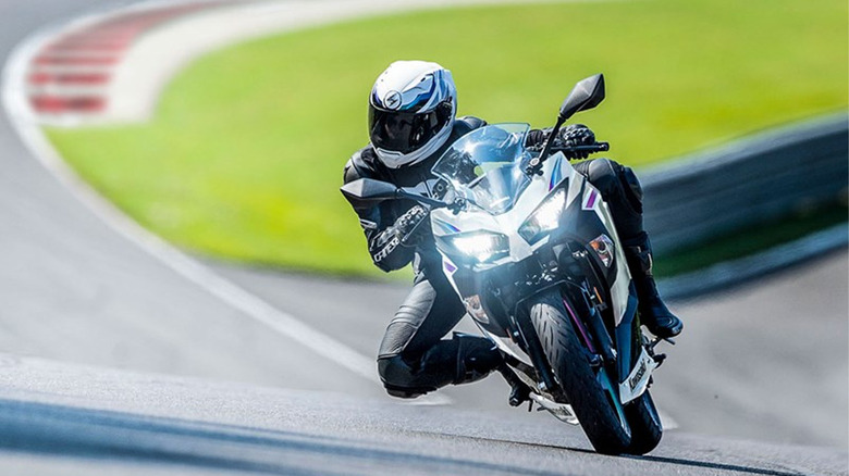 person riding Kawasaki Ninja 400 on track