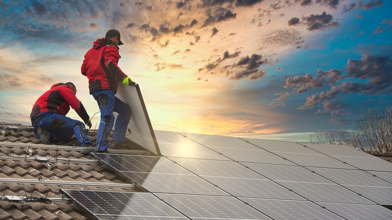 Workers installing solar panels