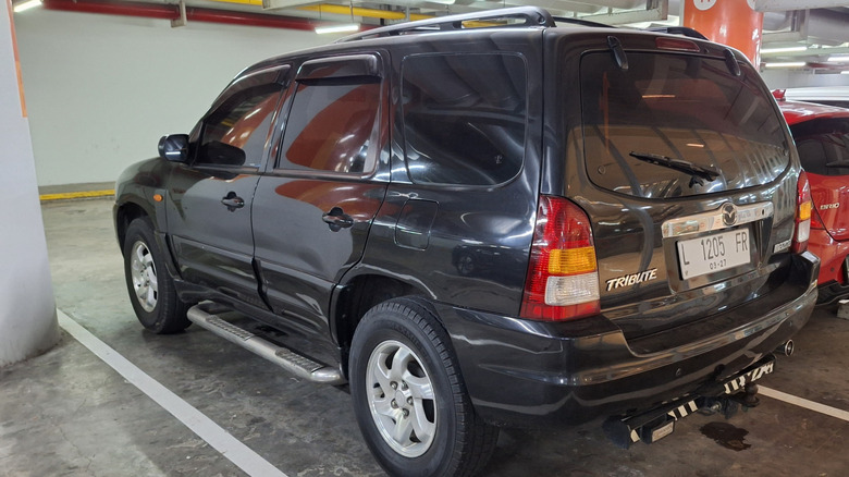 The rear of a black Mazda Tribute photographed in a parking lot