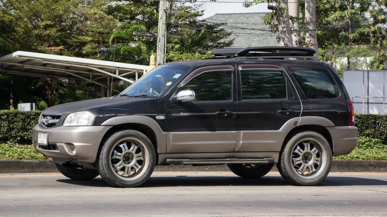 A black Mazda Tribute cruising on the road