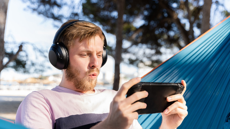 Person playing game on a handheld gaming console