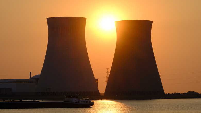 Silhouette of nuclear power plant smokestacks at sunset