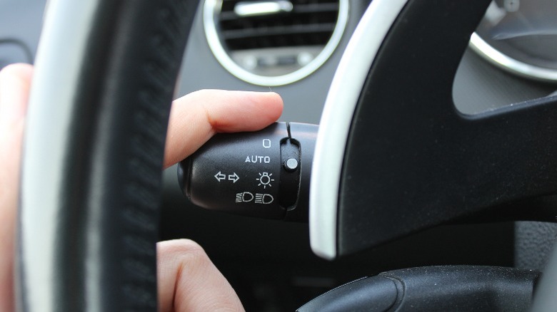 Finger pushing turn signal lever