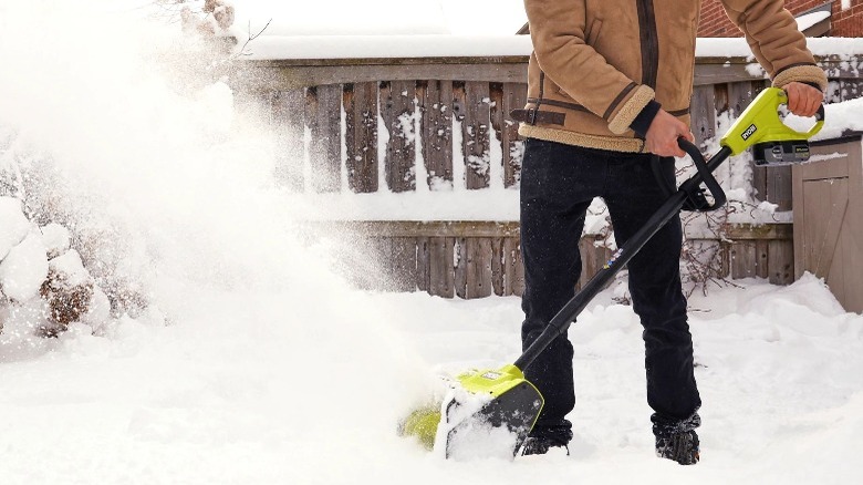 Person using electric snow shovel