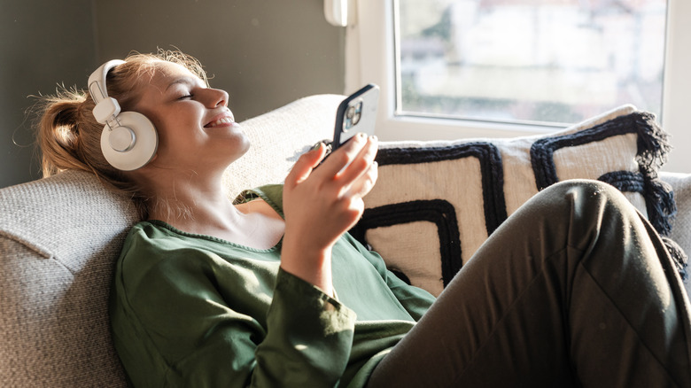 woman listening to something on iphone