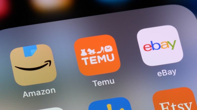 Temu app with Amazon and eBay apps on a phone