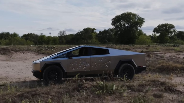 Cybertruck with bullet holes in exoskeleton panel