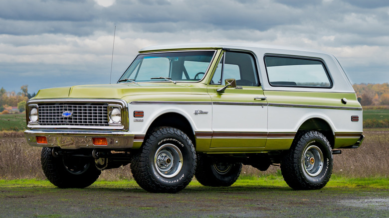 Drive side view of a green Chevrolet K5 Blazer parked on the grass